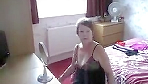Sexy uk milf slut dressing in front of window