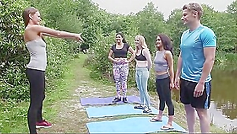 Girls and a boy do yoga outdoor